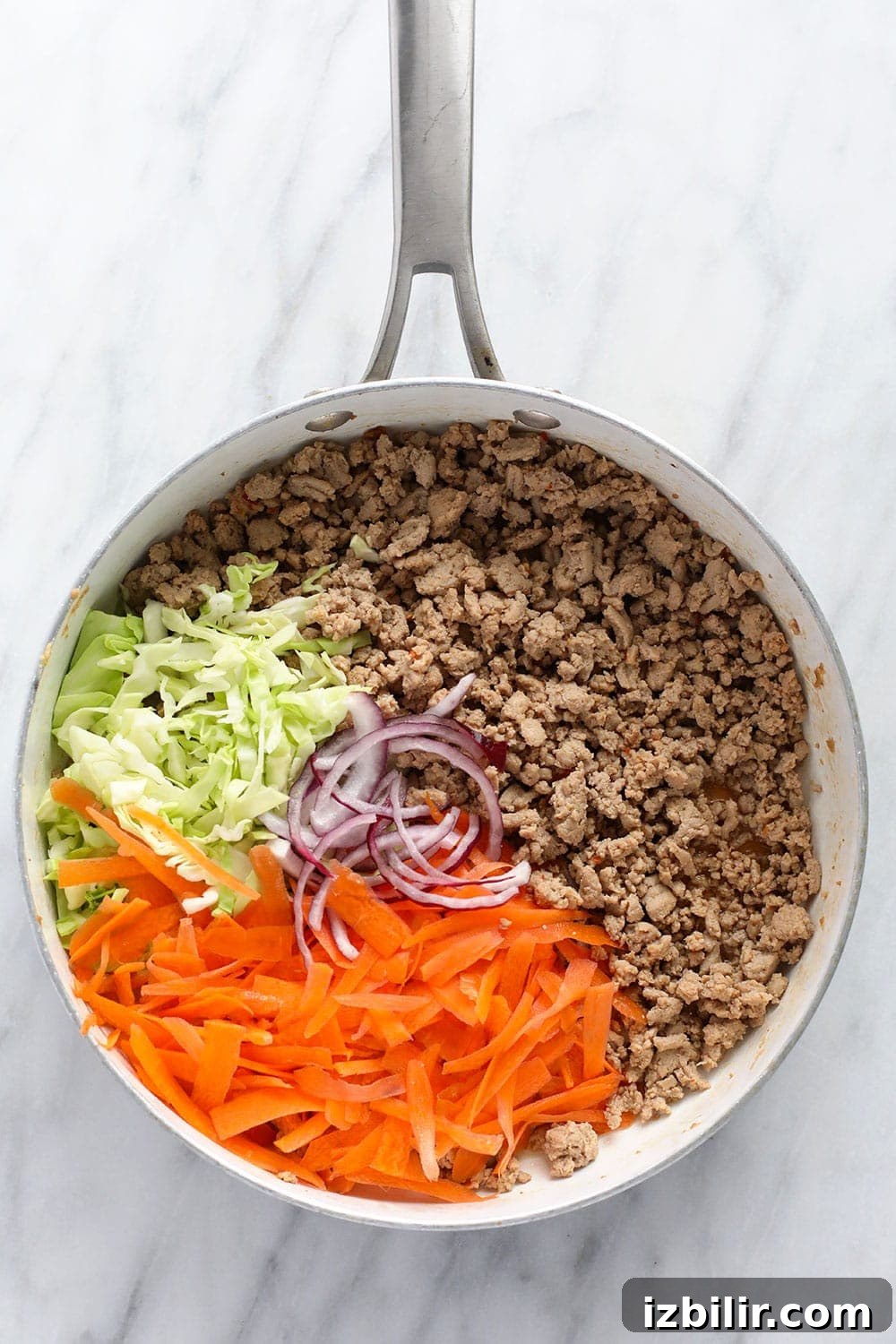 egg roll in a bowl recipe ingredients in a skillet ready to be sauteed