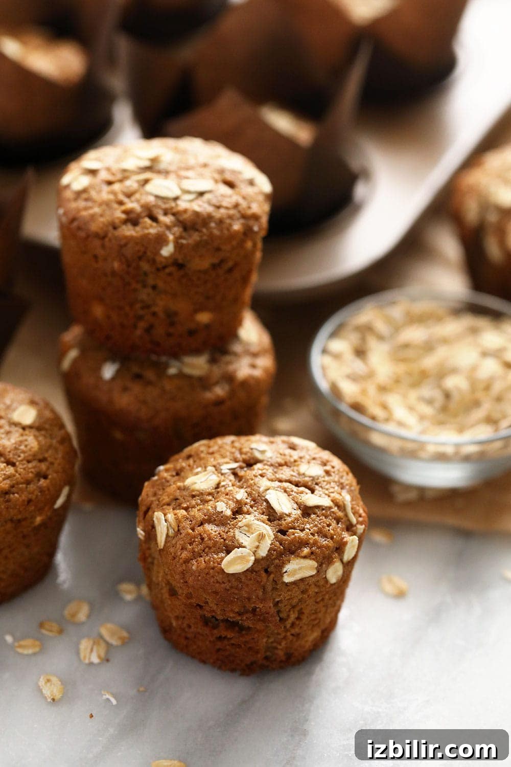 Classic Oatmeal Muffins Recipe 2 classic oatmeal muffins topped with rolled oats