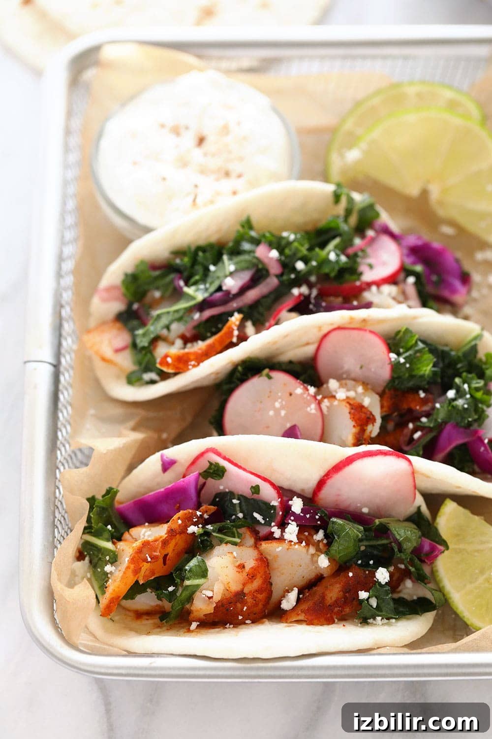 This baked fish taco recipe is flavorful, easy to make, and perfect for a 30-minute meal all year round! Fish tacos in a basket