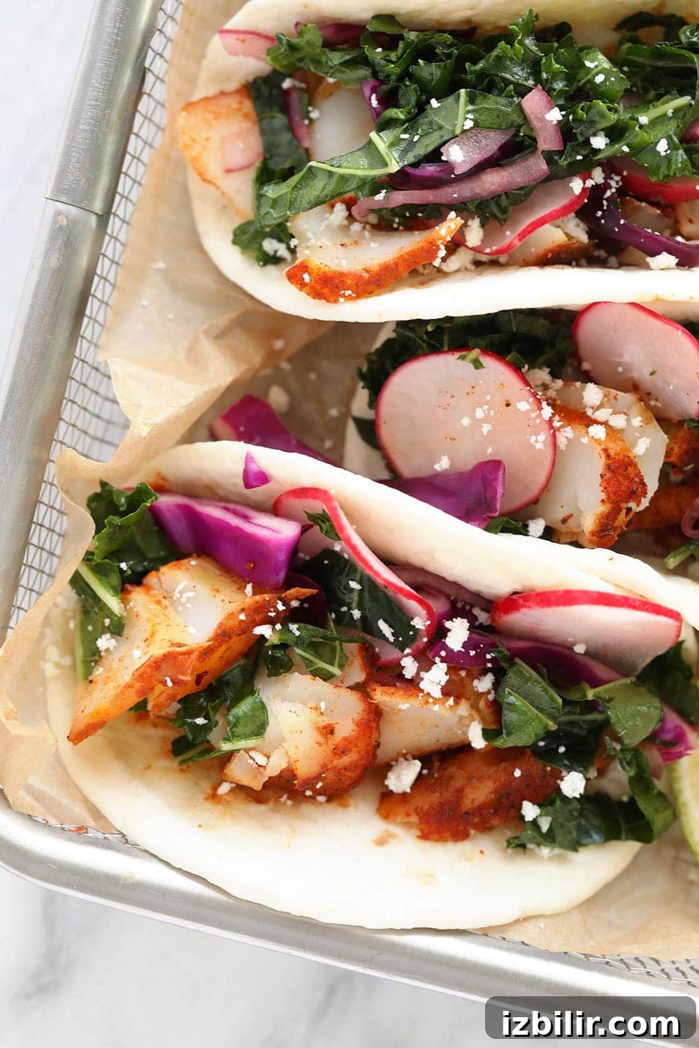 This baked fish taco recipe is flavorful, easy to make, and perfect for a 30-minute meal all year round! Fish tacos in a basket