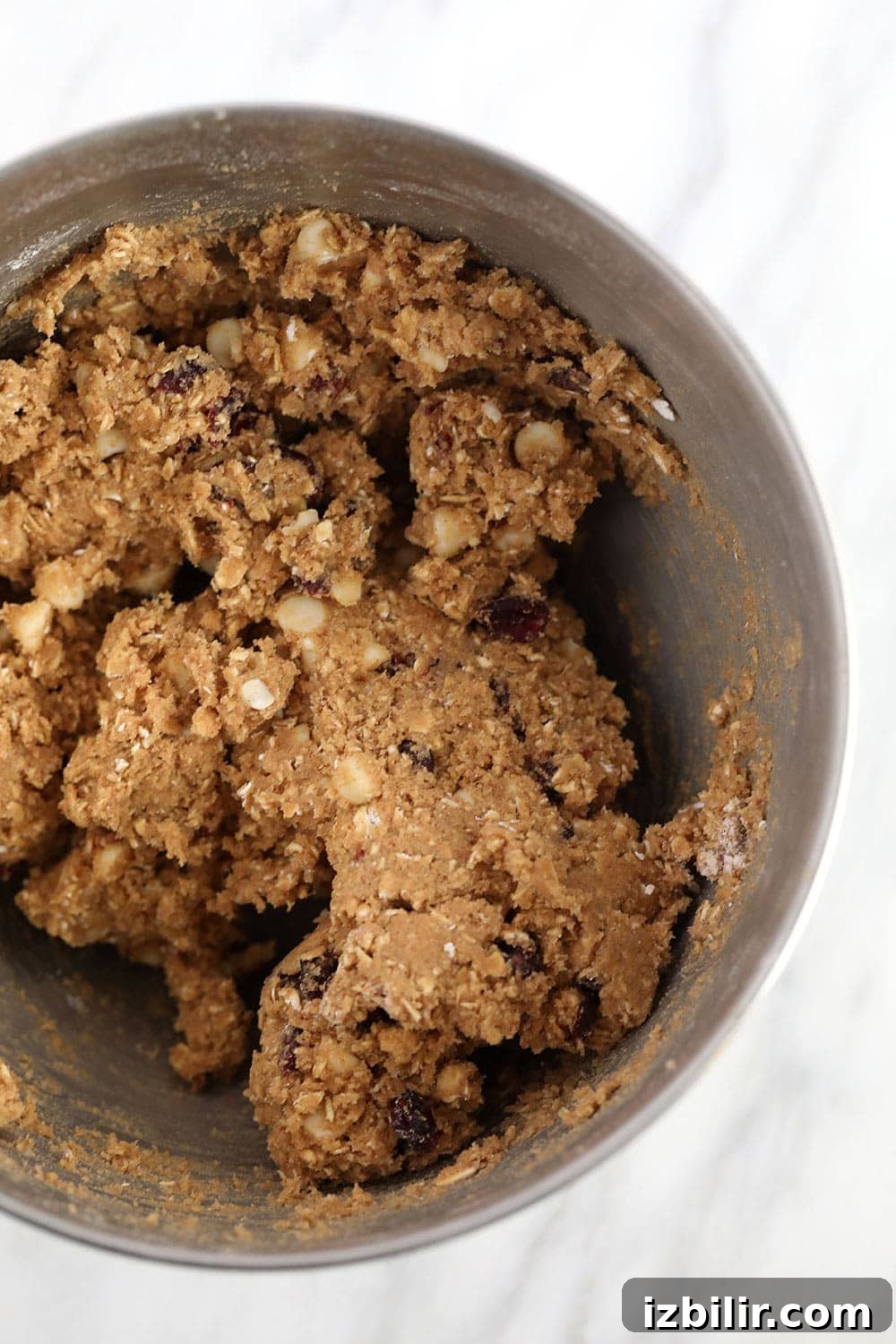 Cookie batter for white chocolate cranberry oatmeal cookies white chocolate cranberry oatmeal cookie batter in a bowl