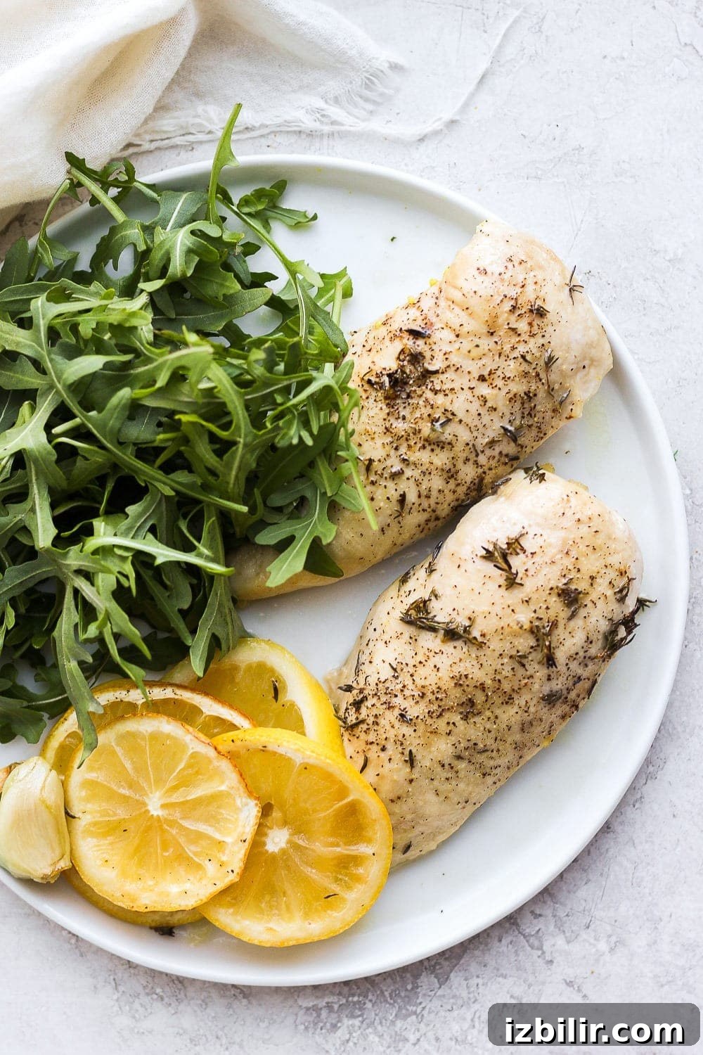 Baked lemon chicken breast on a plate.