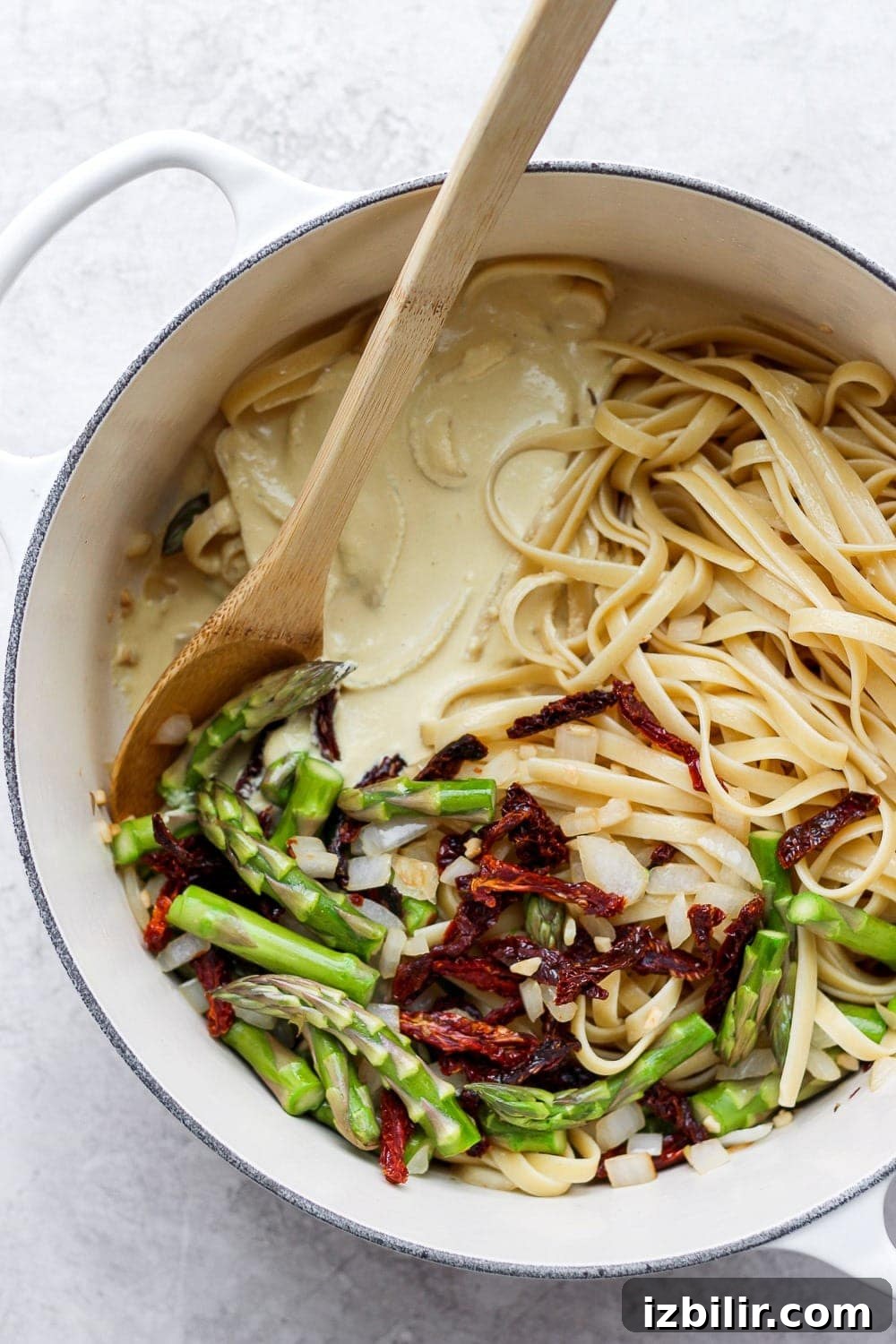 Creamy Vegan Asparagus Pasta Recipe 5 creamy vegan asparagus pasta in a dutch oven ready to be tossed together with veggies and creamy sauce