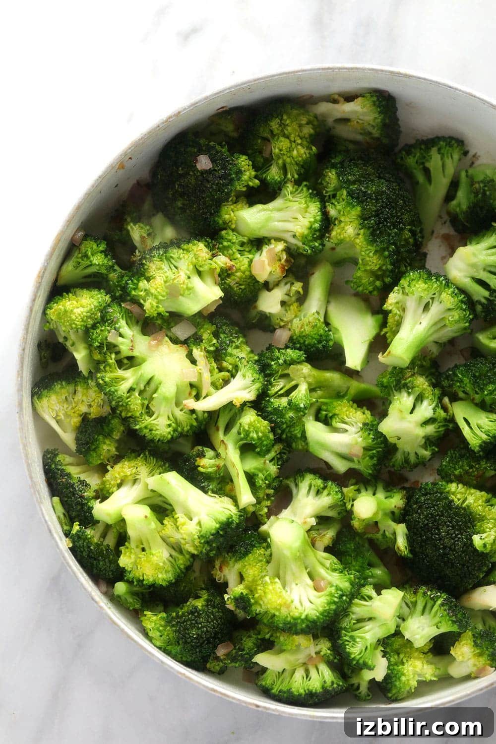 Sautéed Broccoli and Onion sautéed broccoli and diced onion in a skillet