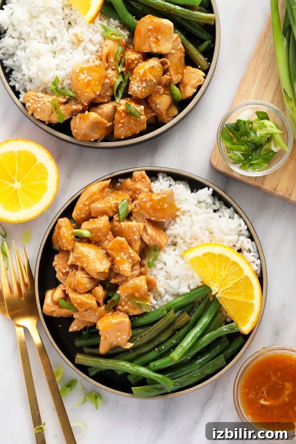 Instant Pot Orange Chicken orange chicken on a plate with rice and beans