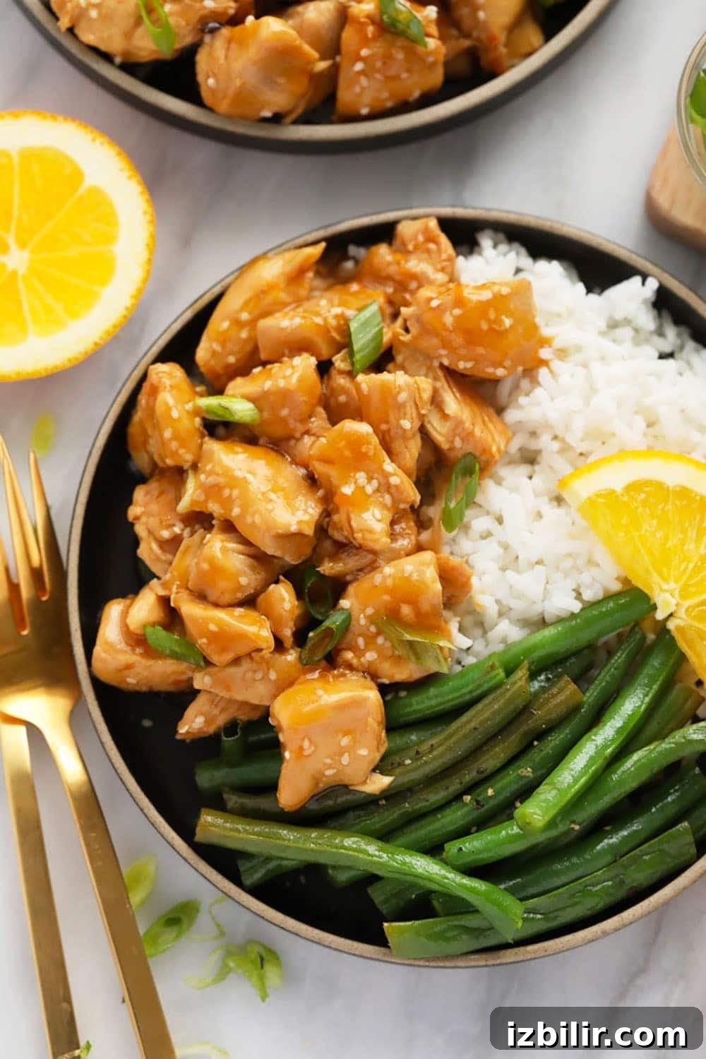 Orange chicken with rice and green beans Orange chicken, white rice, and green beans on a plate