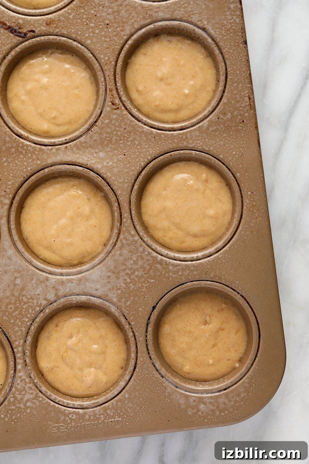muffin batter in muffin tin