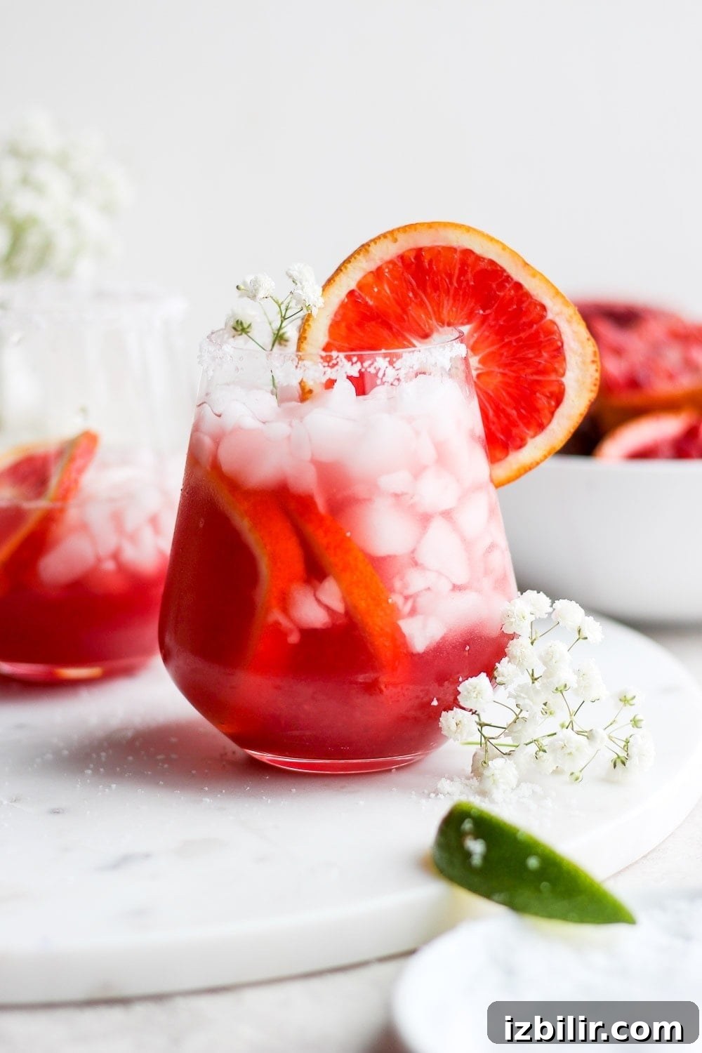 Blood orange margarita with fresh blood orange juice, simple syrup, lime juice, and tequila. Blood orange margarita in a glass