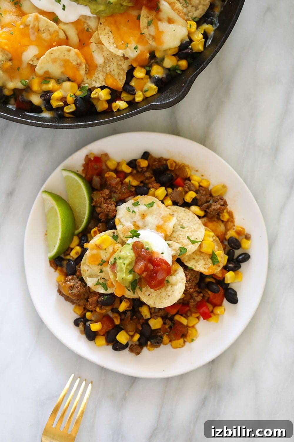 Cheesy Taco Casserole Recipe with Ground Beef 5 easy taco casserole on a plate topped with greek yogurt and guacamole