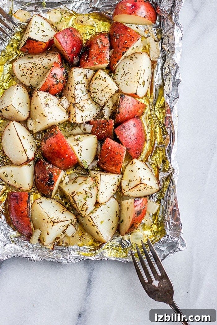 Seasoned potatoes on foil red potatoes on tin foil covered in olive oil and spices