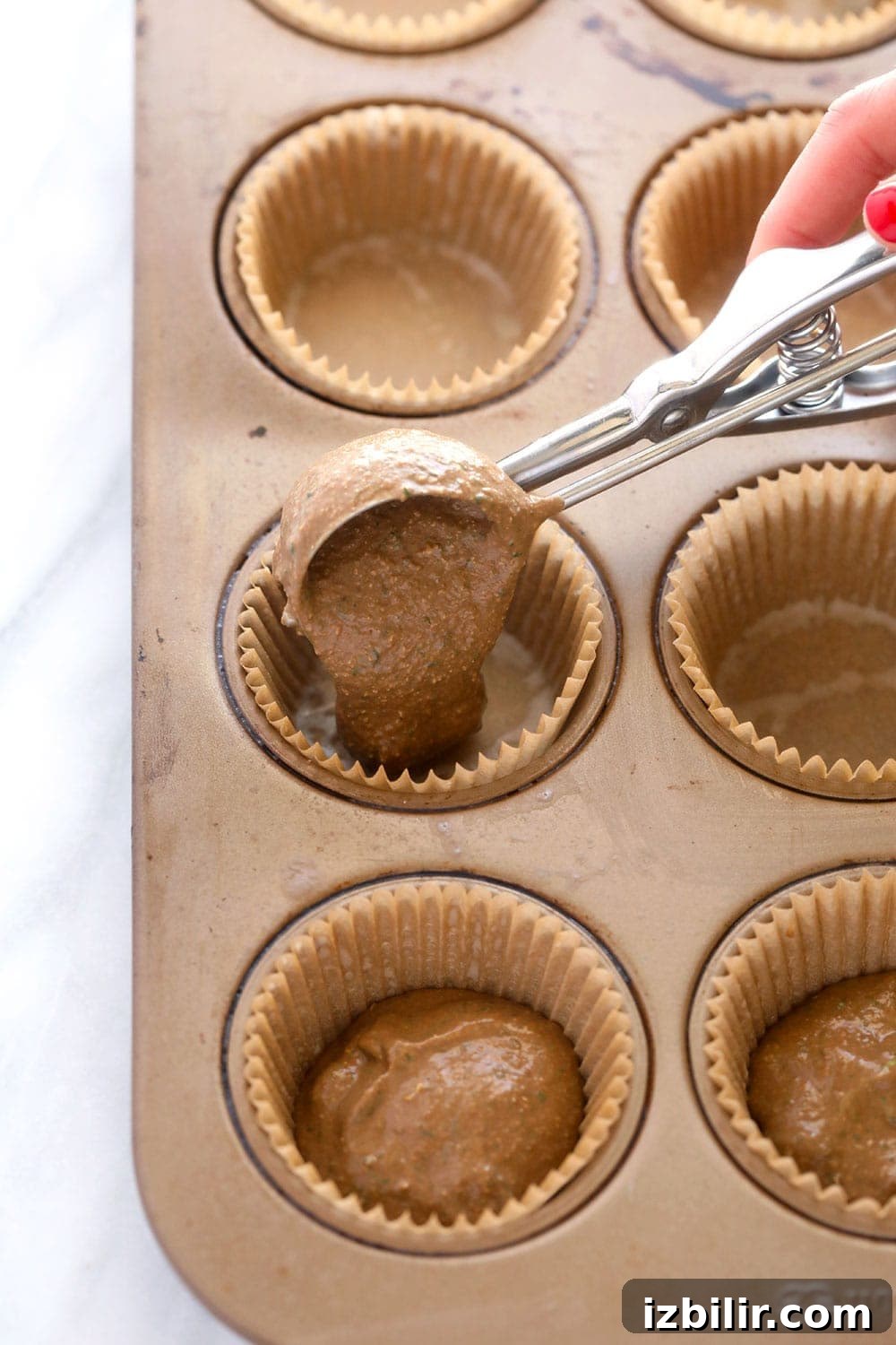 Filling muffin cups with batter Filling muffin cups with batter