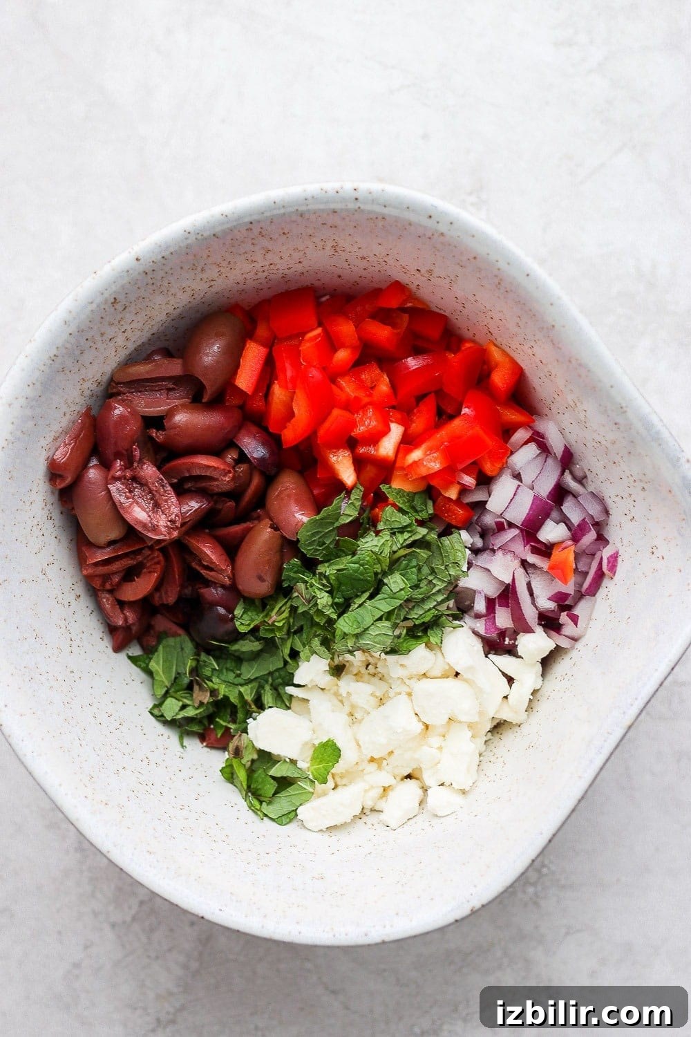 Ingredients for the Greek salad in a large bowl Ingredients for the greek salad in a large bowl