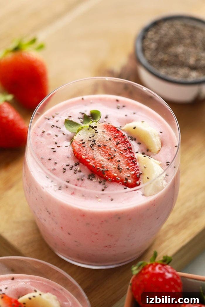 Creamy pink strawberry chia seed smoothie in a glass