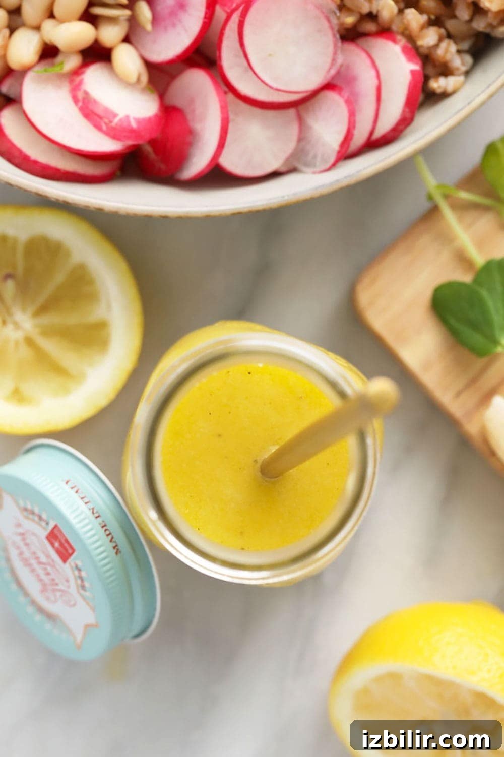 homemade lemon vinaigrette dressing in a jar ready to dress a salad