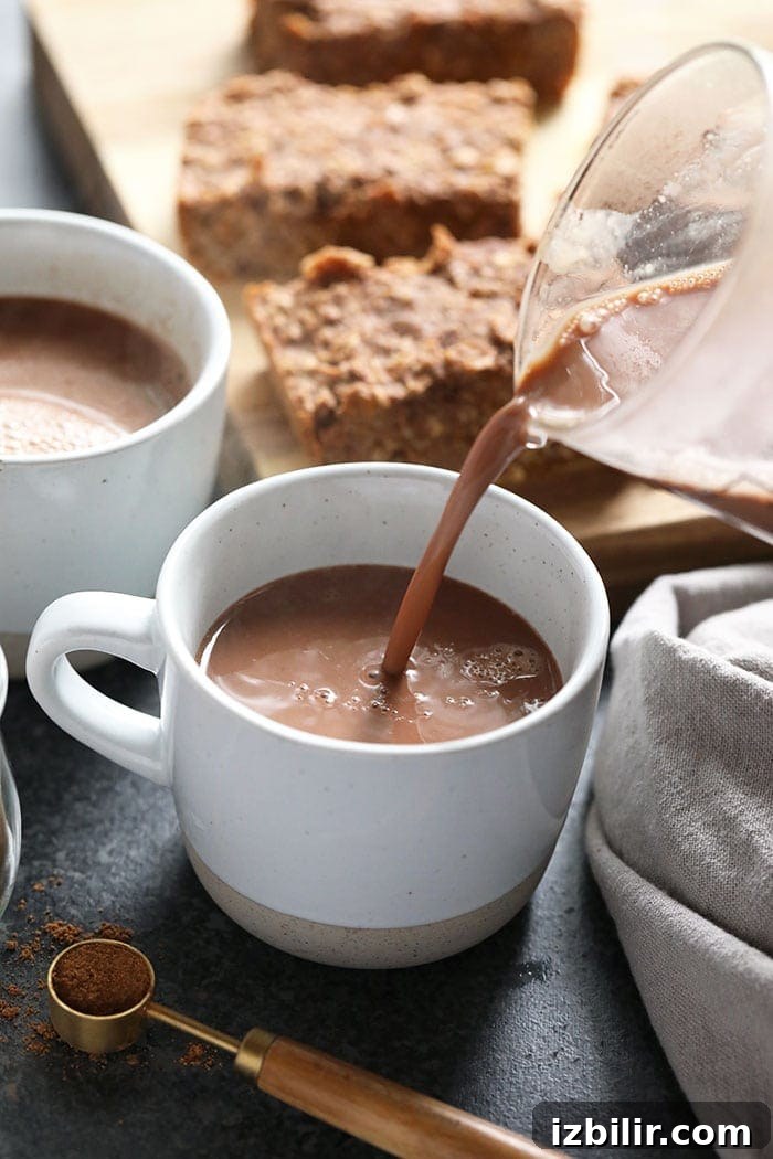 Pouring Vegan Chai Hot Chocolate vegan chai hot chocolate being poured in a mug