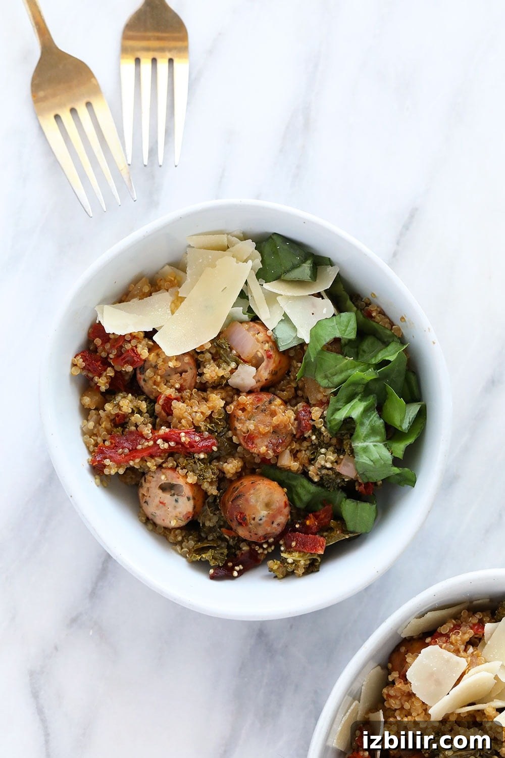 One of our most popular quinoa casserole recipes is this Italian Chicken Sausage Quinoa Casserole. It's protein-packed and made with sun-dried tomatoes and kale! quinoa casserole in bowl