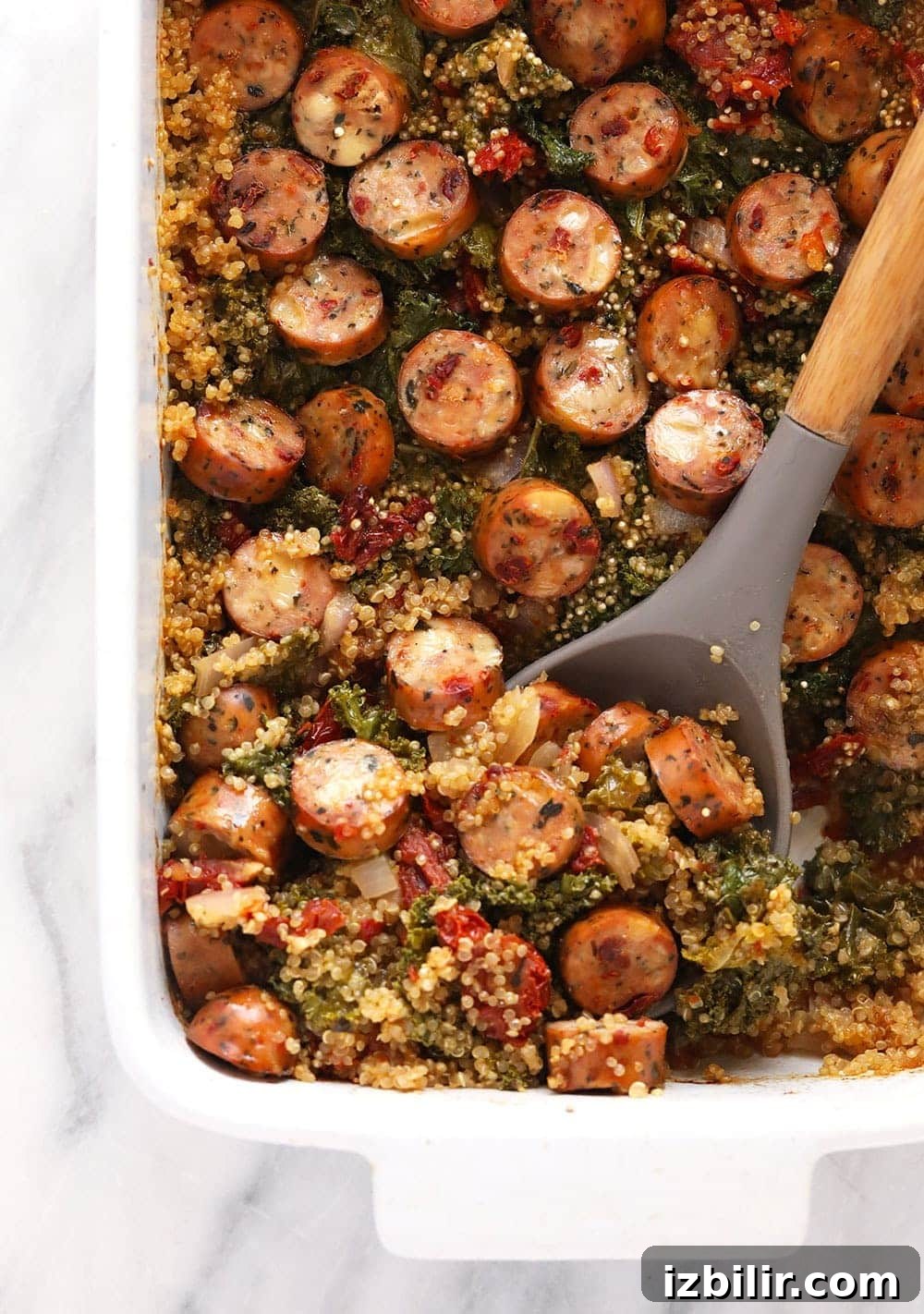 Italian Chicken Sausage Quinoa Casserole ready to serve quinoa casserole with large serving spoon