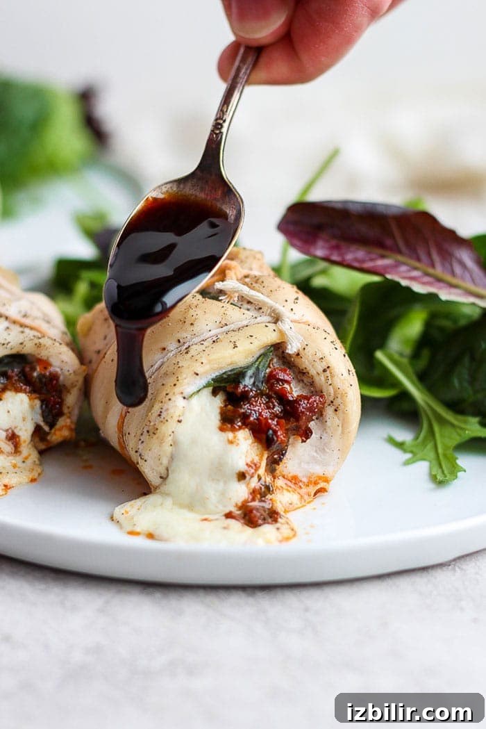 Caprese stuffed chicken breast drizzled with balsamic glaze.