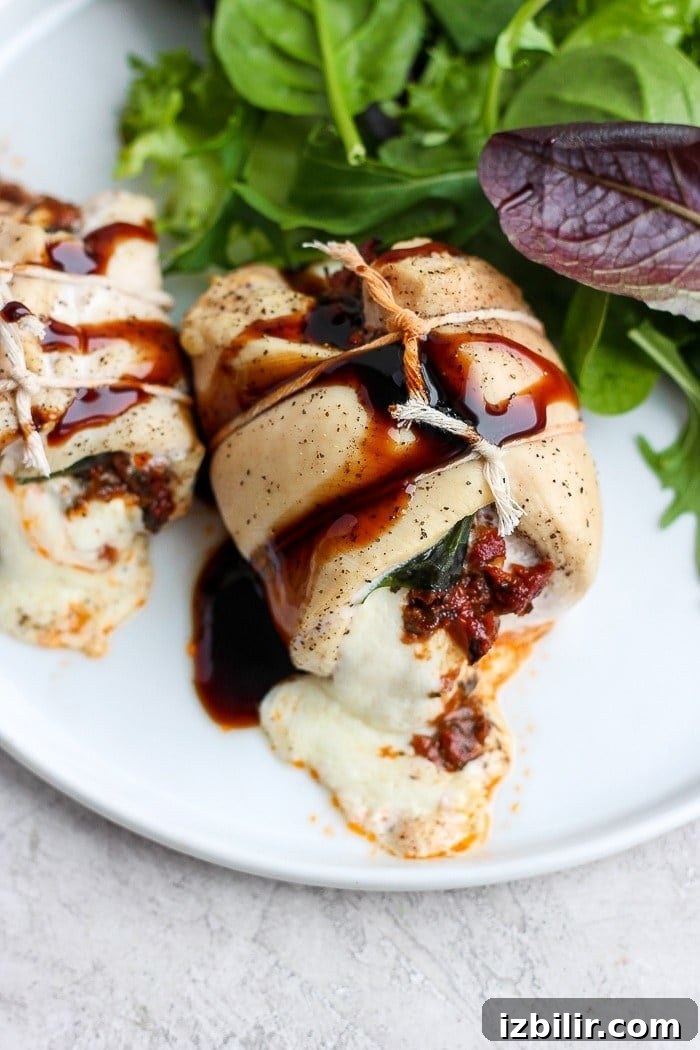 caprese stuffed chicken breast served on a plate