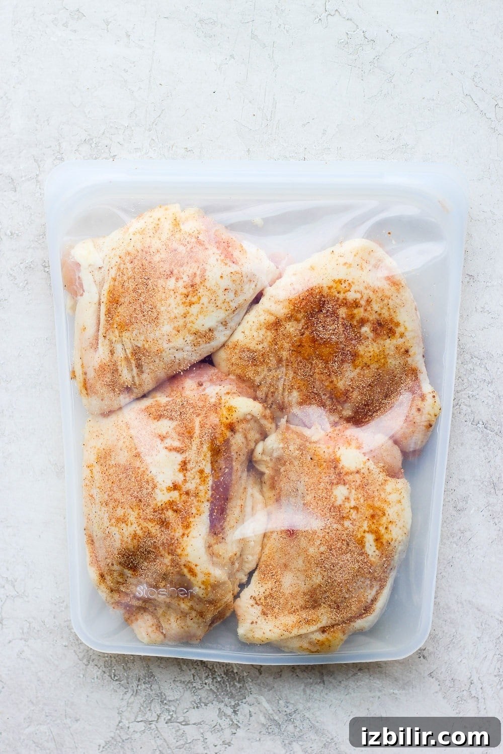 Seasoned chicken thighs in a bag ready for the sous vide. chicken thighs in Stasher bag