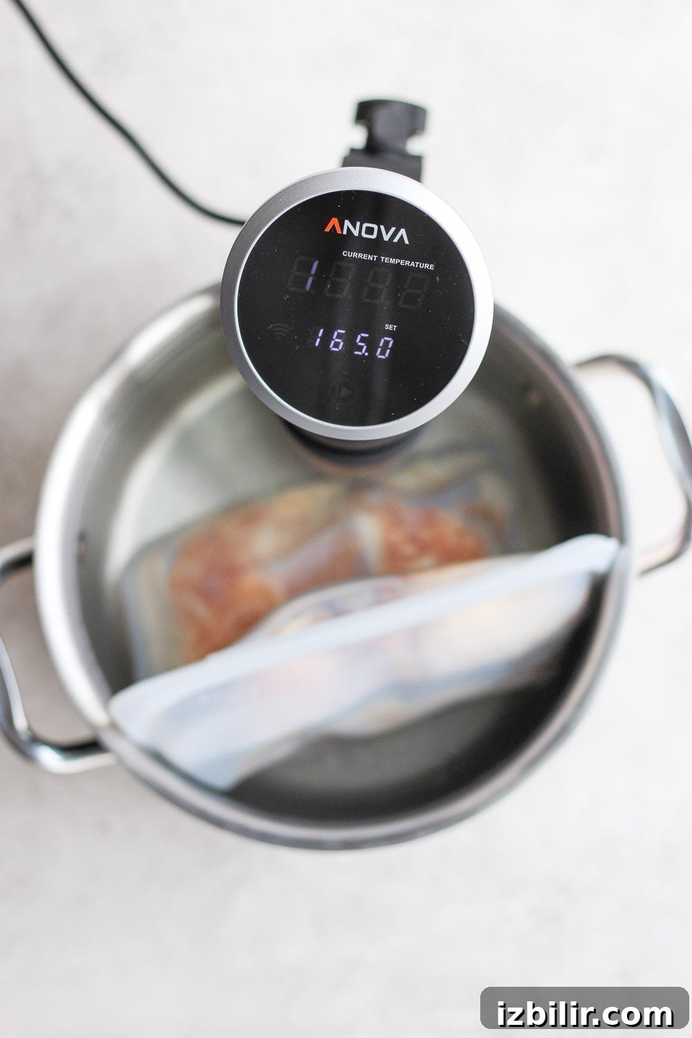 Set your sous vide to 165ºF for safely cooked chicken thighs. sous vide set to 165 degrees