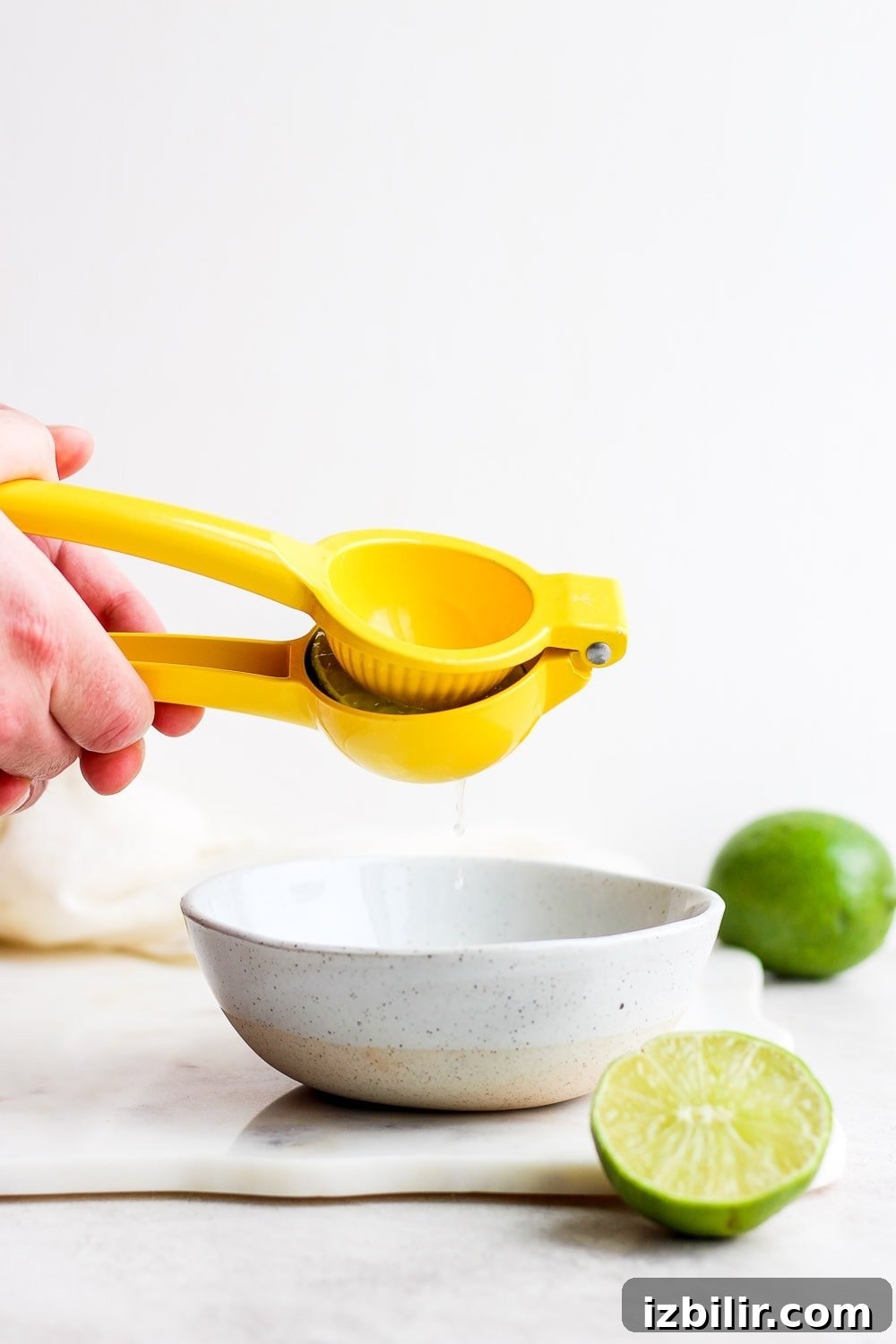 This is the BEST skinny margarita on the internet and it's made with 4 simple ingredients - tequila, fresh lime juice, ice, and honey/agave simple syrup! juicing limes
