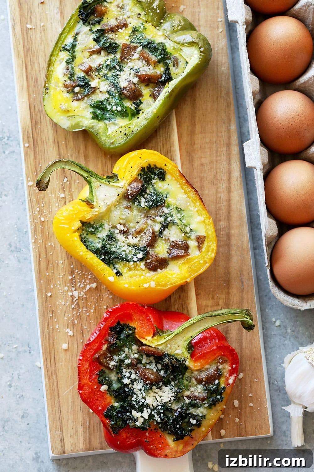 Cheesy Breakfast Sausage Stuffed peppers on a cutting board