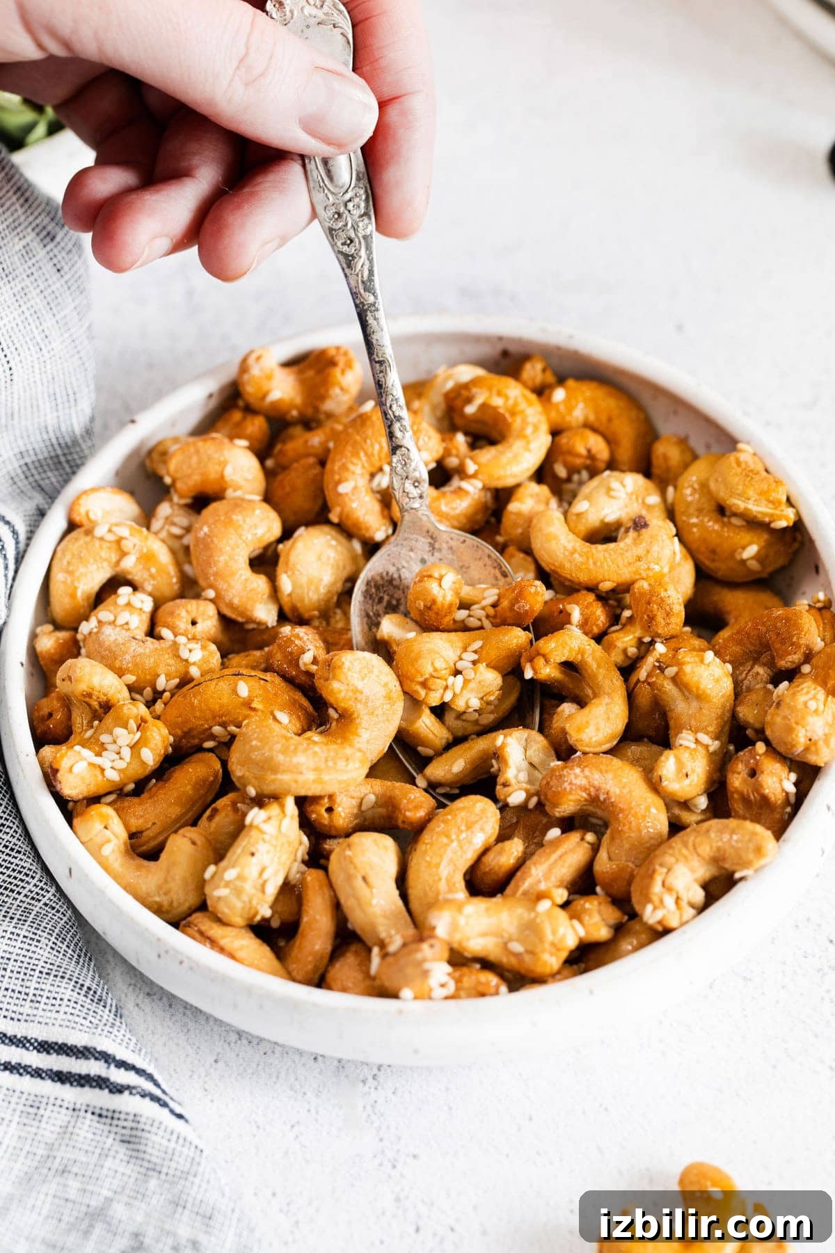 roasted cashews in bowl with spoon