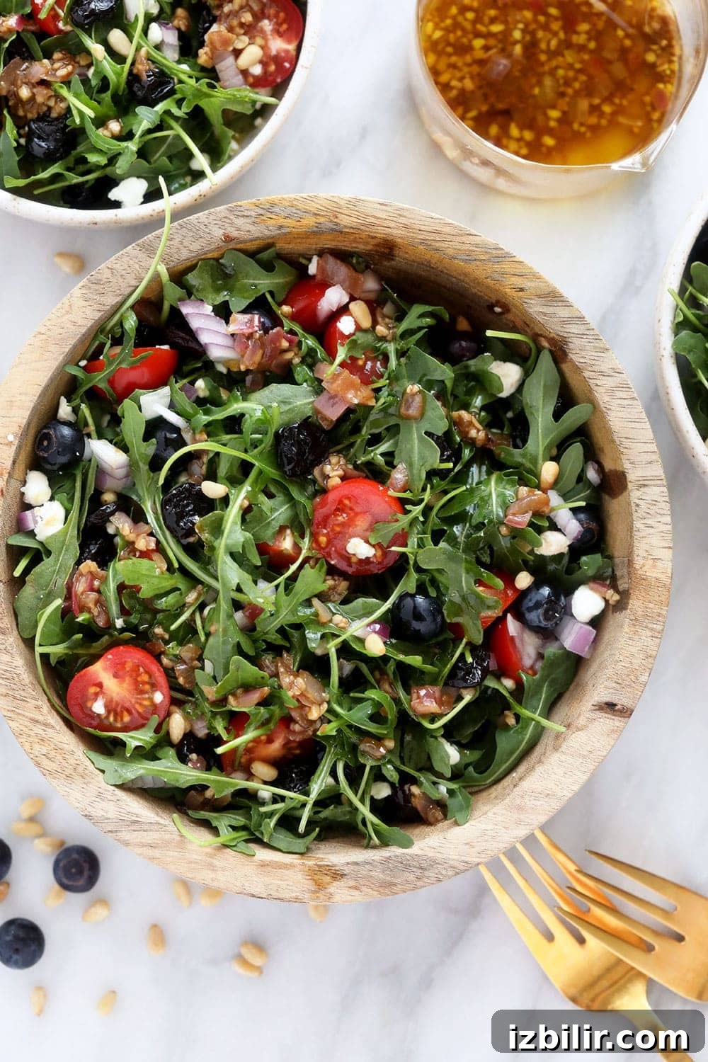 Fresh Arugula Salad with Lemon Vinaigrette and Parmesan 2 Arugula Salad in a mixing bowl.
