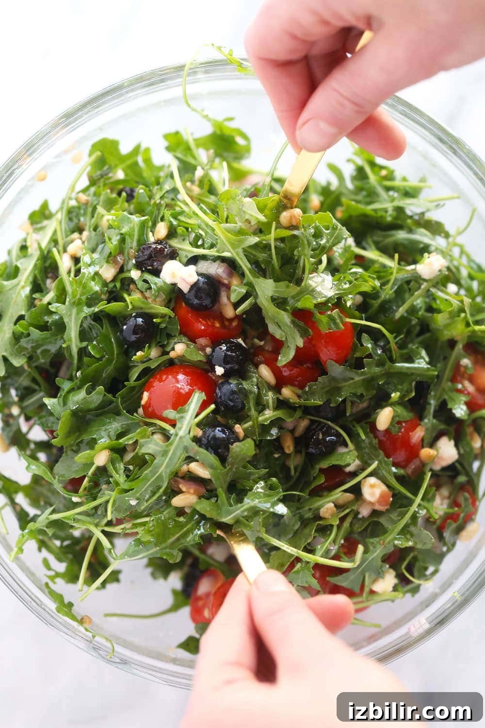 This arugula salad is perfect for meal prep or as a side. Arugula salad in a mixing bowl.