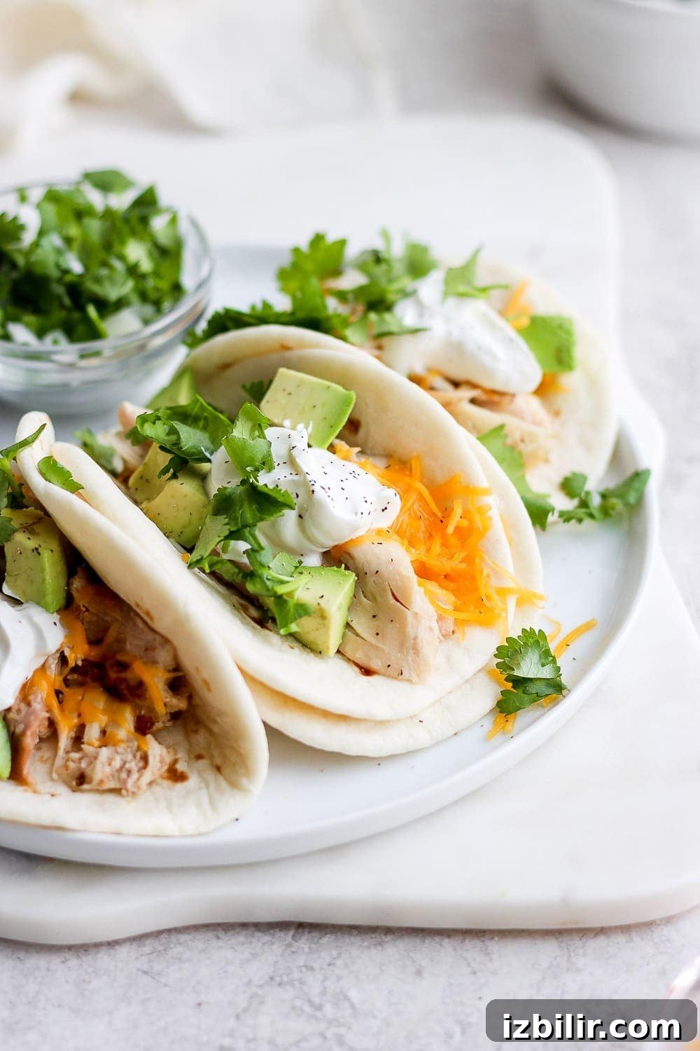 shredded chicken tacos on a plate