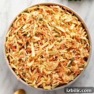 creamy coleslaw in a bowl topped with parsley
