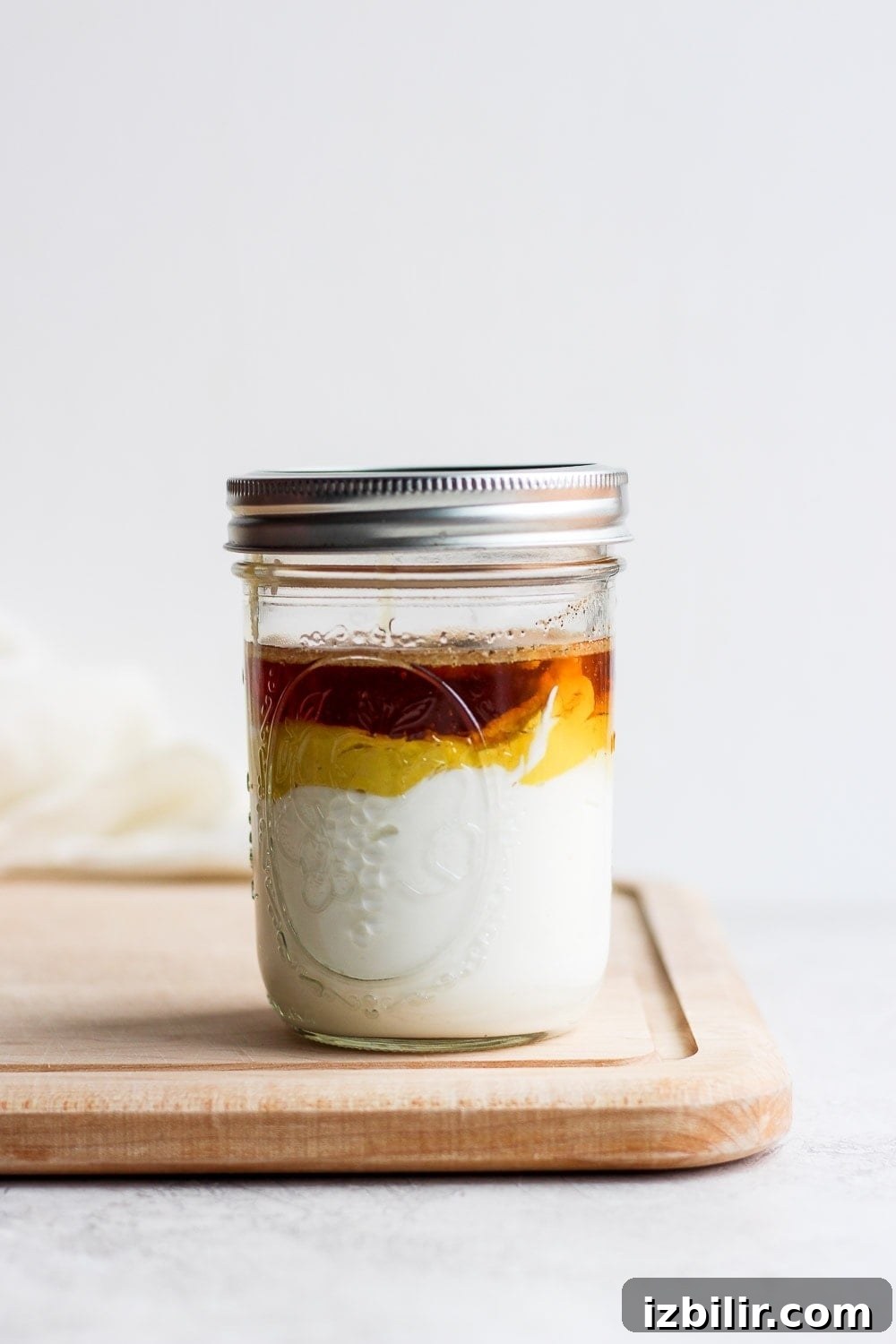 ingredients stacked in a mason jar on a cutting board