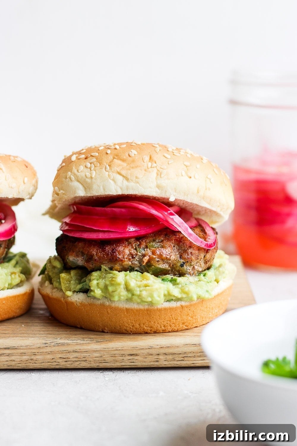 Say hello to the Best Juicy Turkey Burger you've ever had! These turkey burgers are always delicious, and never dry. Enjoy! turkey burgers on a bun, ready to be served.