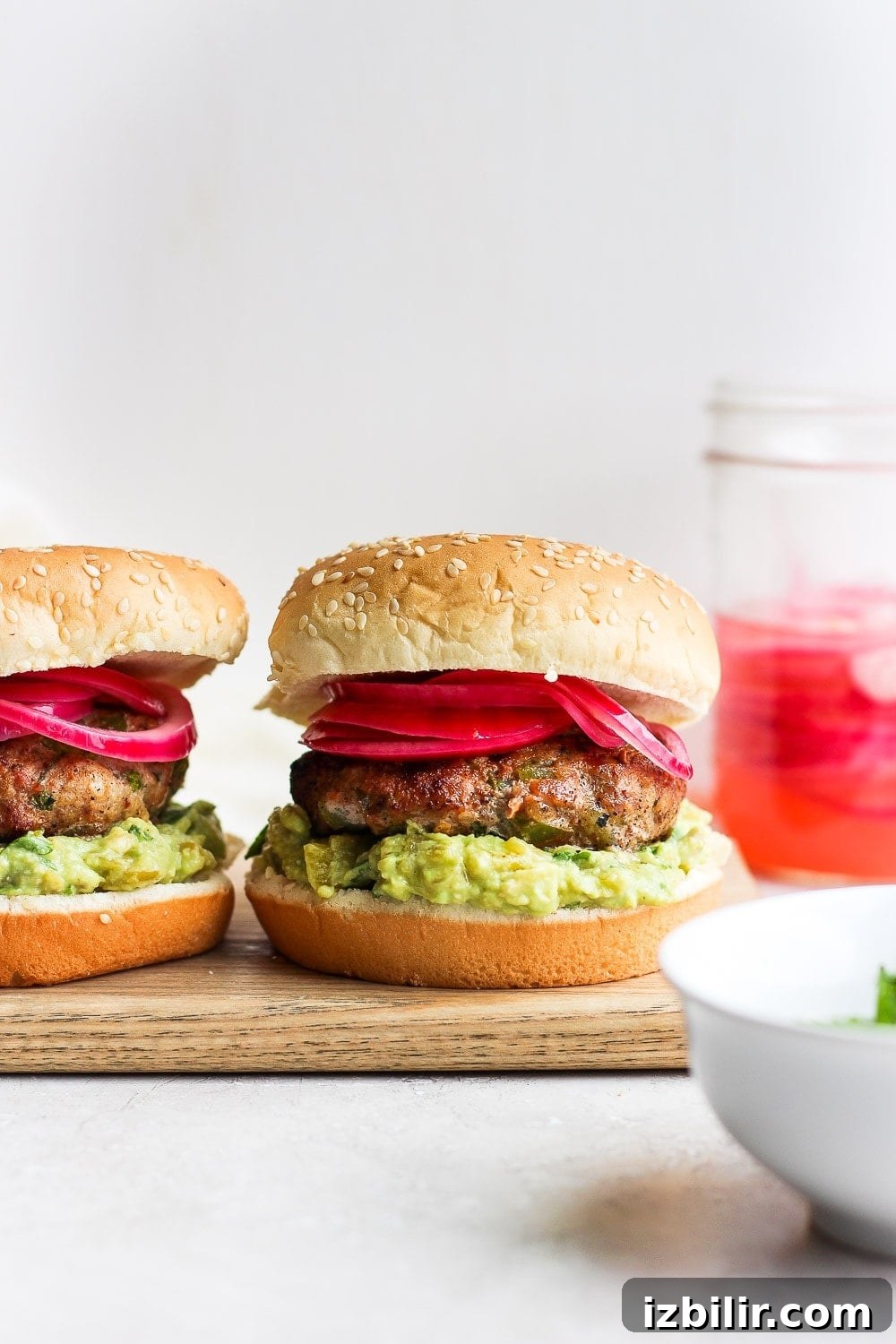 Turkey burgers with pickled onions and avocado mash turkey burgers with pickled onions and avocado mash ready to be served.