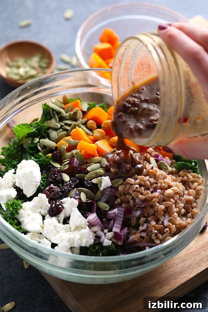 Farro Salad with Kale and Roasted Butternut Squash 6 Pouring dressing over the farro salad.