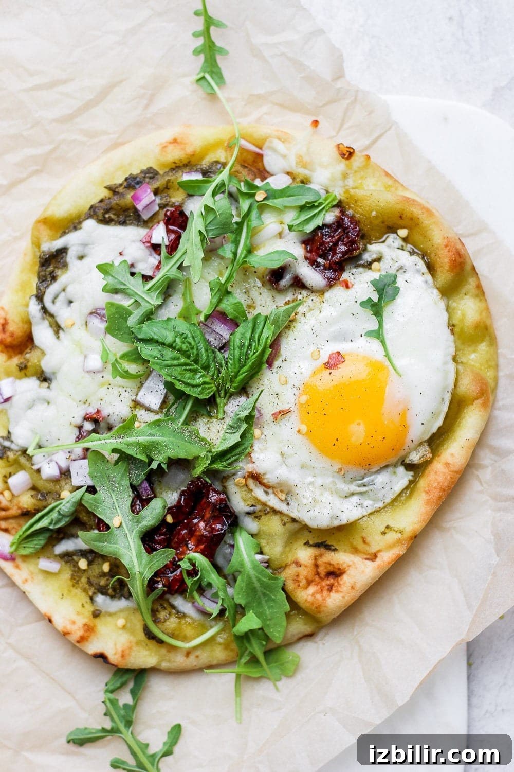 Crispy Naan Breakfast Pizza Recipe with Eggs and Cheese 2 Naan breakfast pizza on a plate.