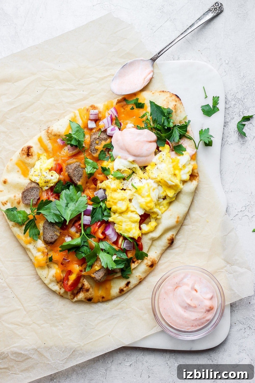 Crispy Naan Breakfast Pizza Recipe with Eggs and Cheese 7 Naan pizza topped with chicken sausage, eggs, tomatoes, and red onion.