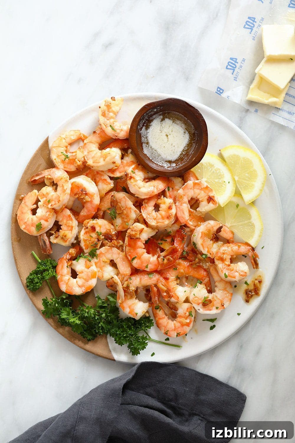 Garlic Butter Shrimp ready in 10 minutes garlic butter shrimp on a plate with fresh lemon slices