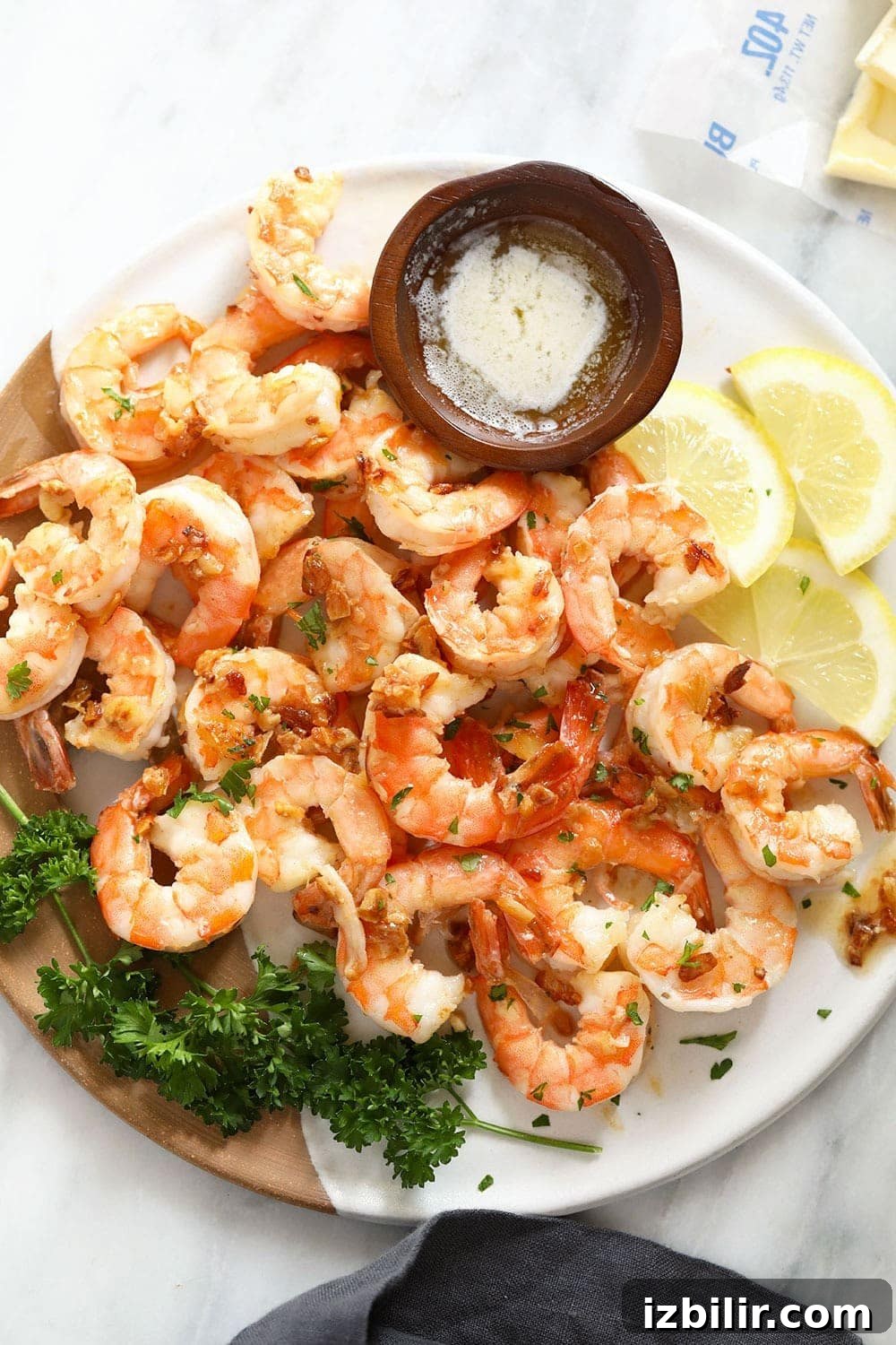 Garlic butter shrimp plated and ready to serve garlic butter shrimp on a plate with butter for dipping