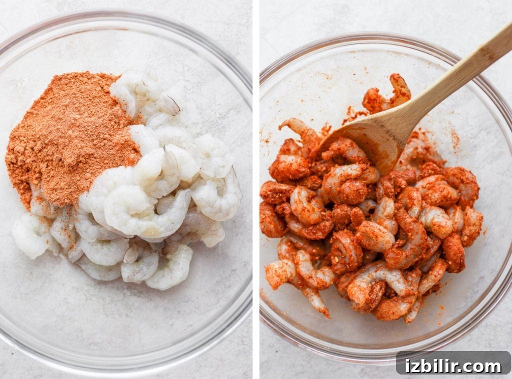 Season the shrimp well for the best flavor. raw shrimp being coated in taco seasoning