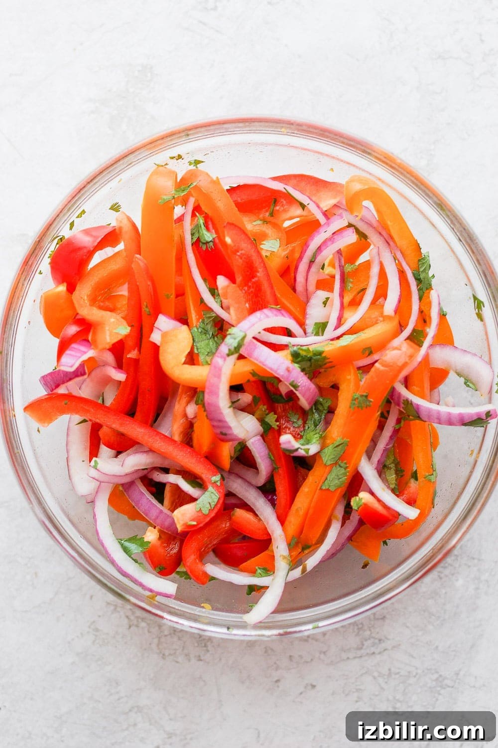 Sweet pepper slaw adds color and crunch. sweet pepper slaw being mixed together in a bowl