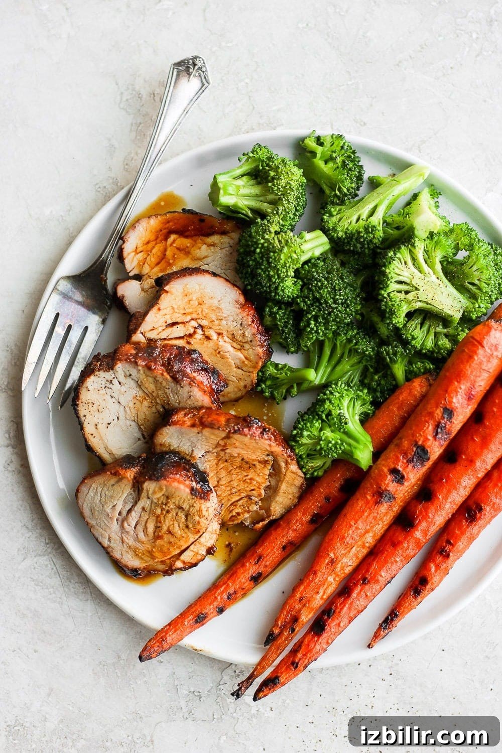 Grilled pork tenderloin with veggies. Sliced pork tenderloin with vegetables.