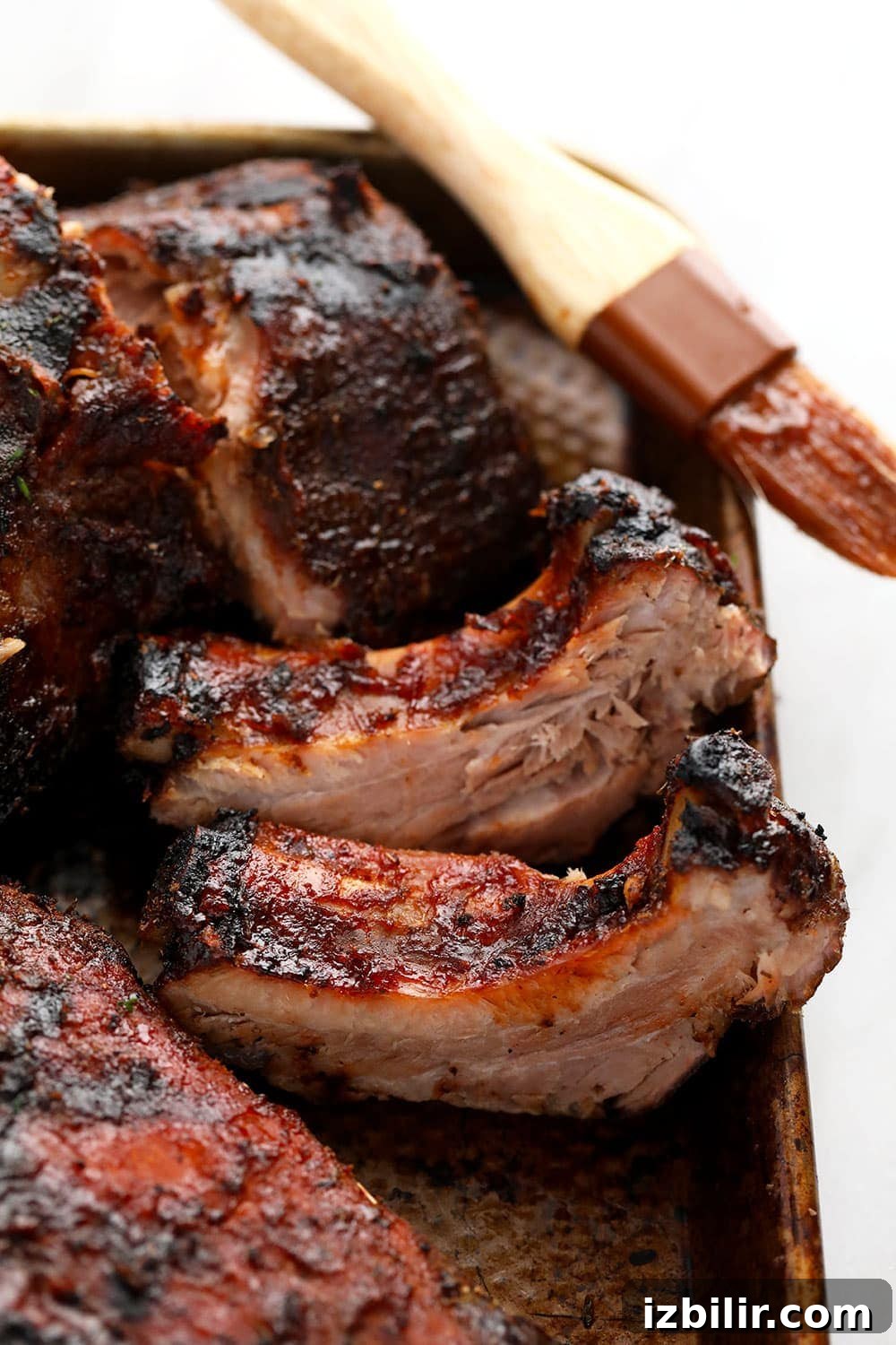 Sous Vide Ribs on a baking sheet with sauce brush