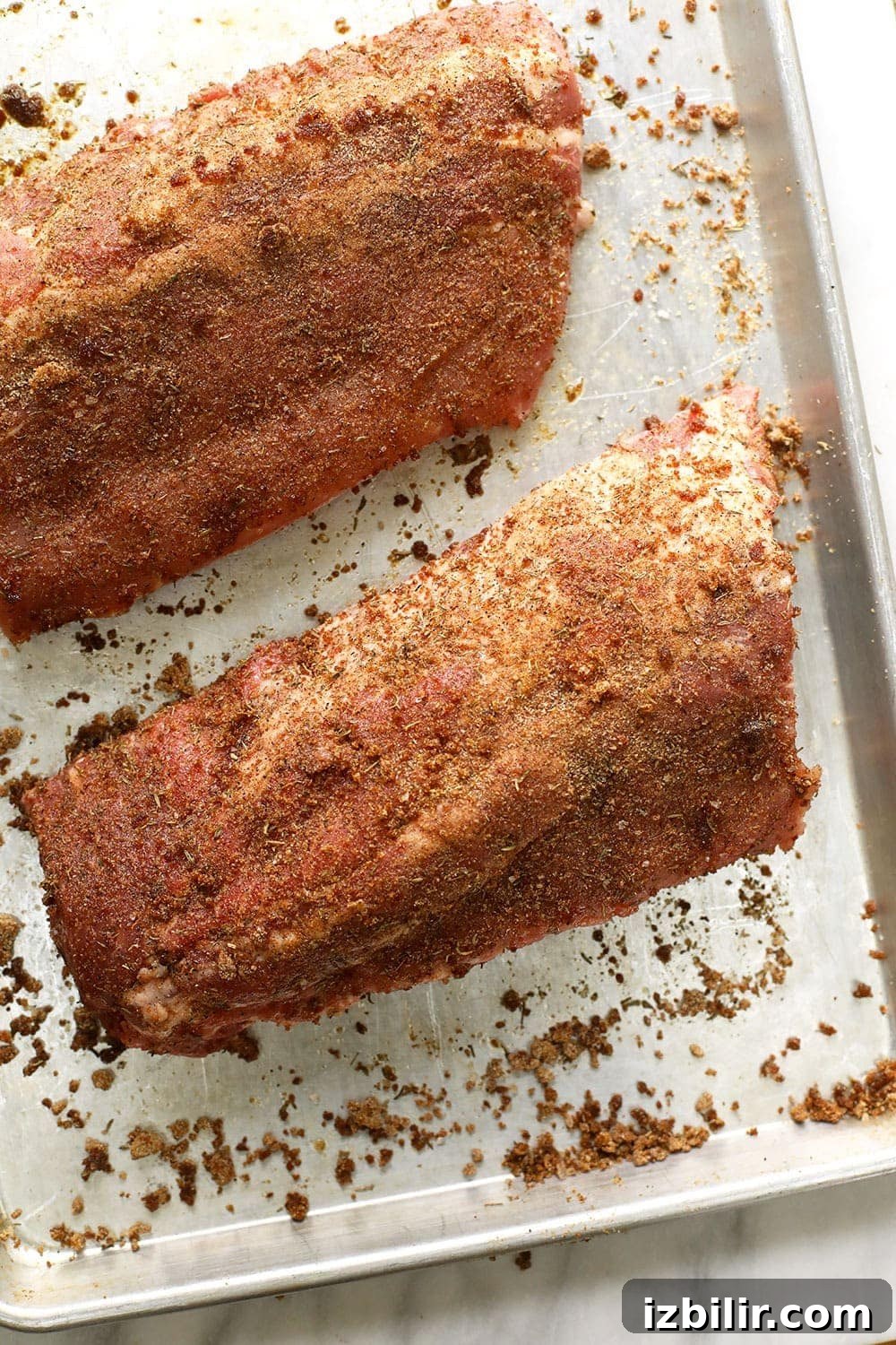 Dry rubbed sous vide ribs on a baking sheet.