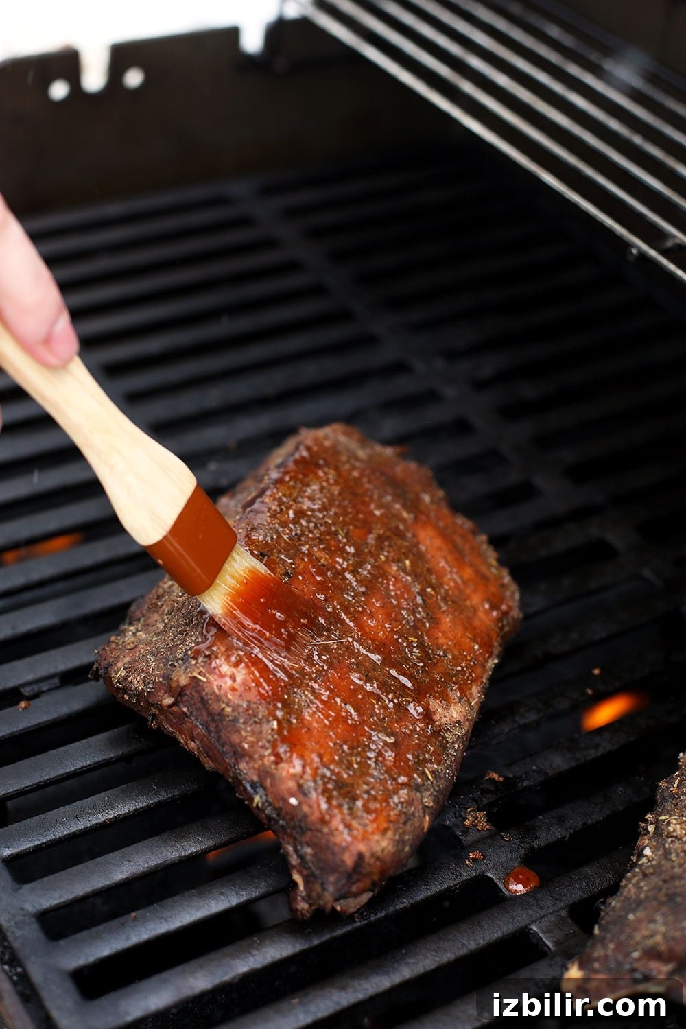 Brushing the sous vide ribs with bbq sauce.