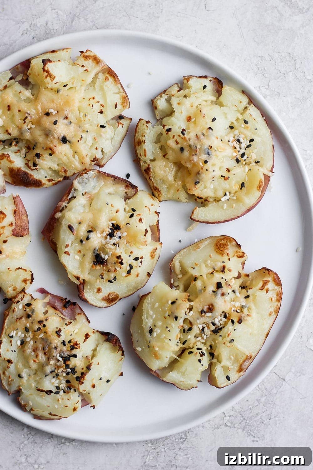 Smashed red potatoes on a plate. 
