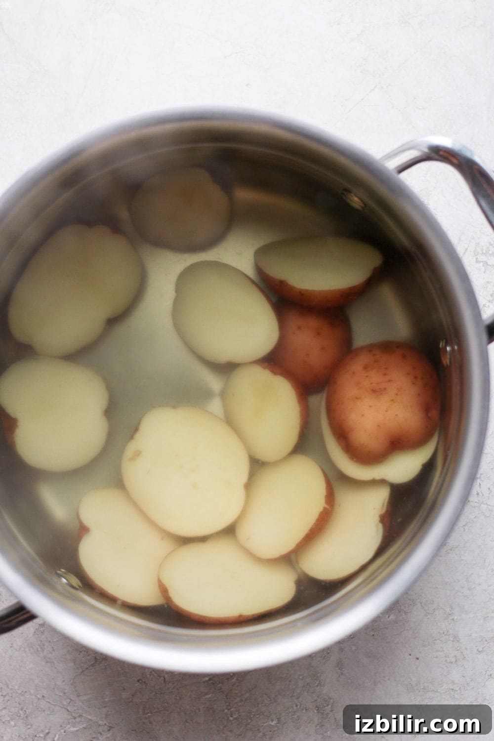 Boiling red potatoes in a large pot of water. 