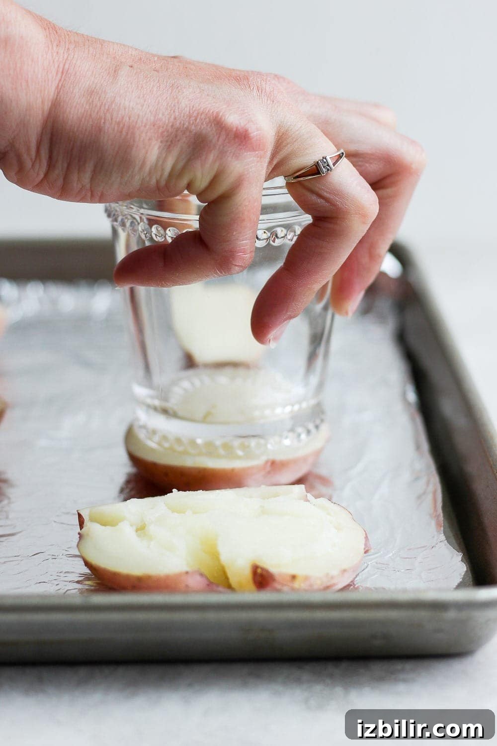 Smashing a boiled red potato with the bottom of a cup! 