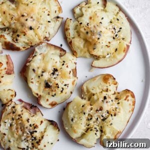 Smashed red potatoes on a plate.